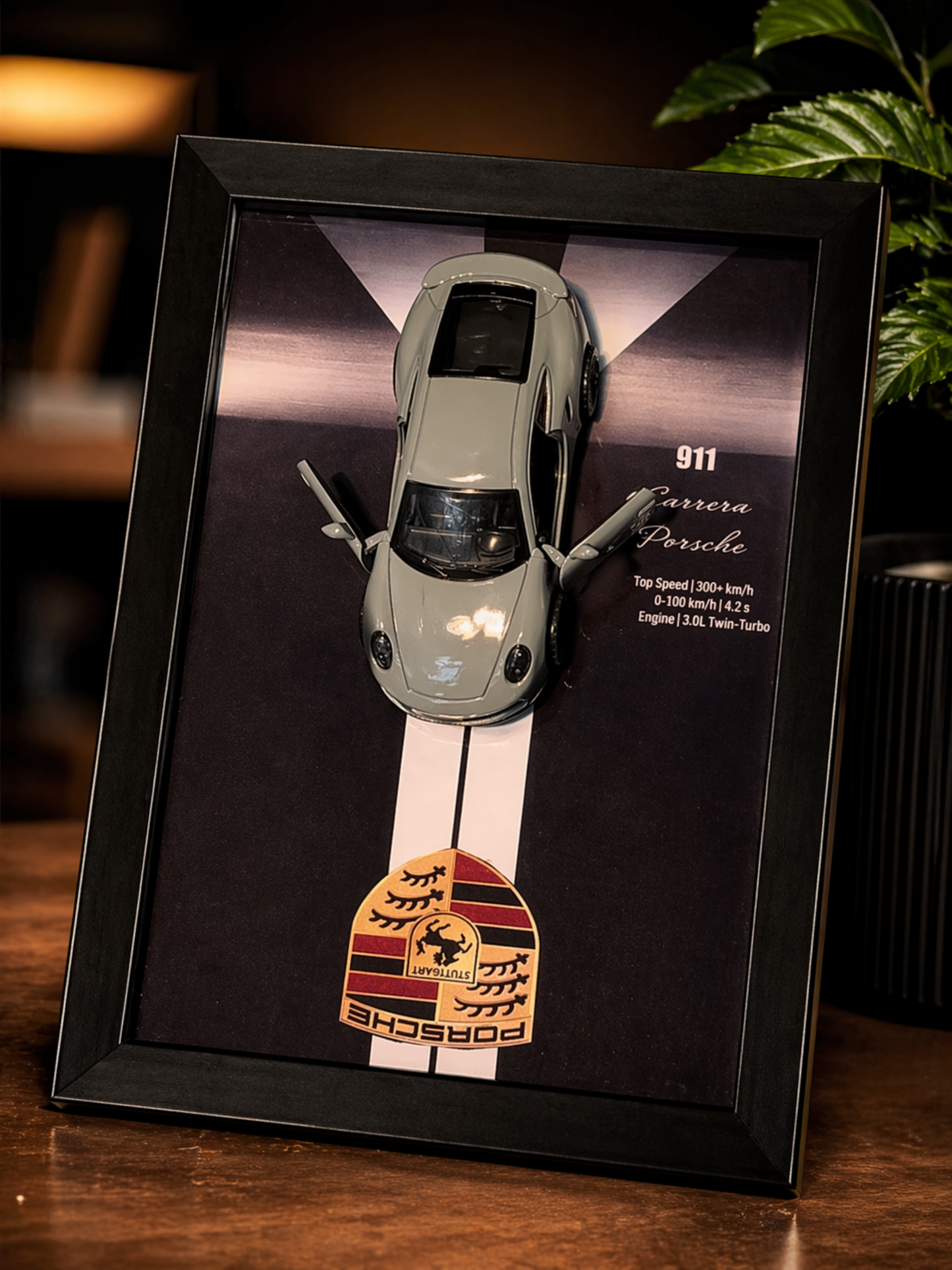 Framed model of a Porsche car with Porsche logo on a dark background