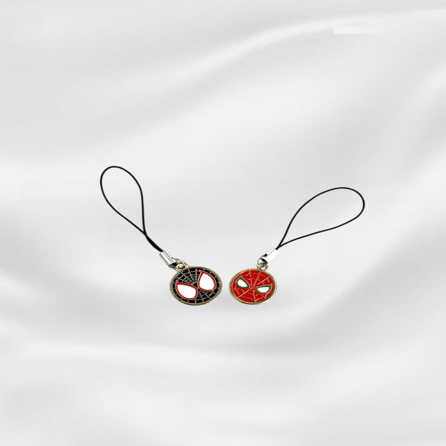 Two phone charm pendants on a white background