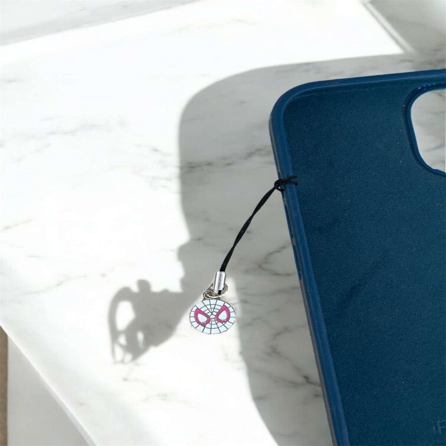 Blue phone case with a charm on a marble surface - Thecharmingcharms09