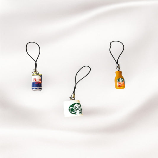 Three small bottle-shaped keychains on a white background